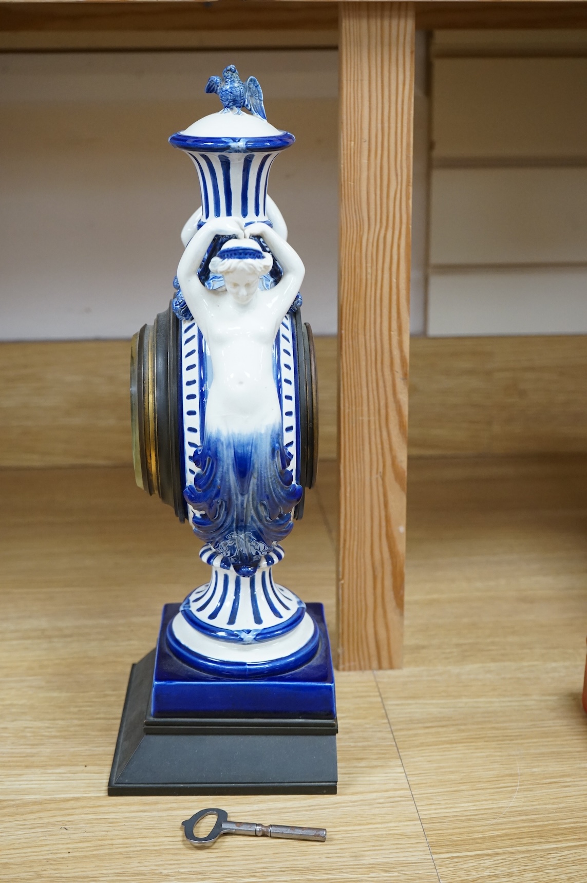 An early 20th century figural glazed ceramic mantle clock, 21cm wide x 40cm high